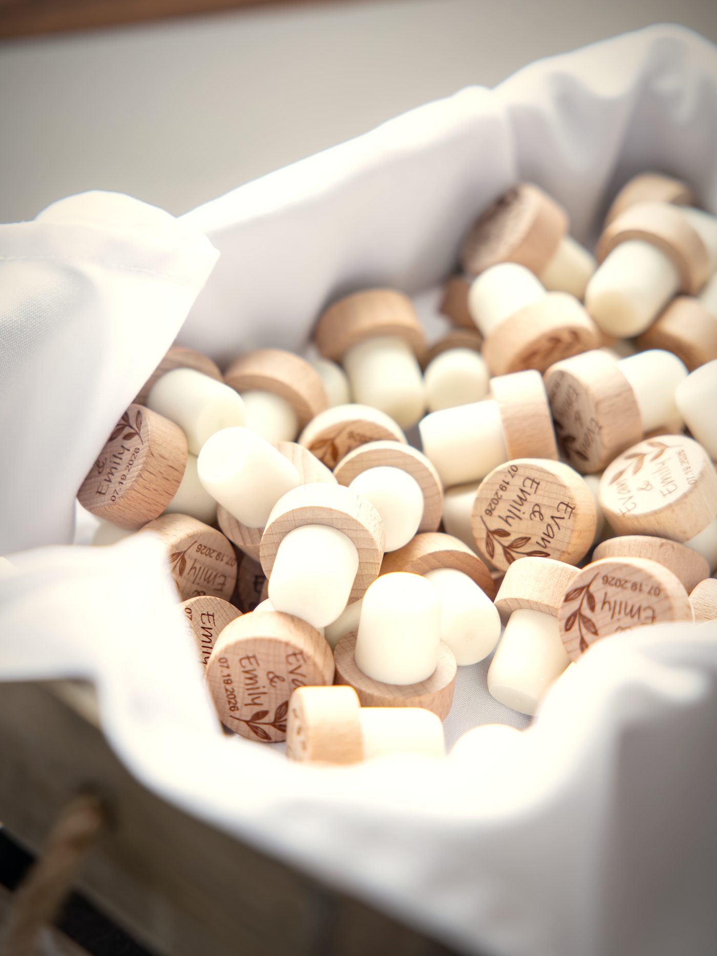 Wax-sealed cork favours piled in a linen-lined crate