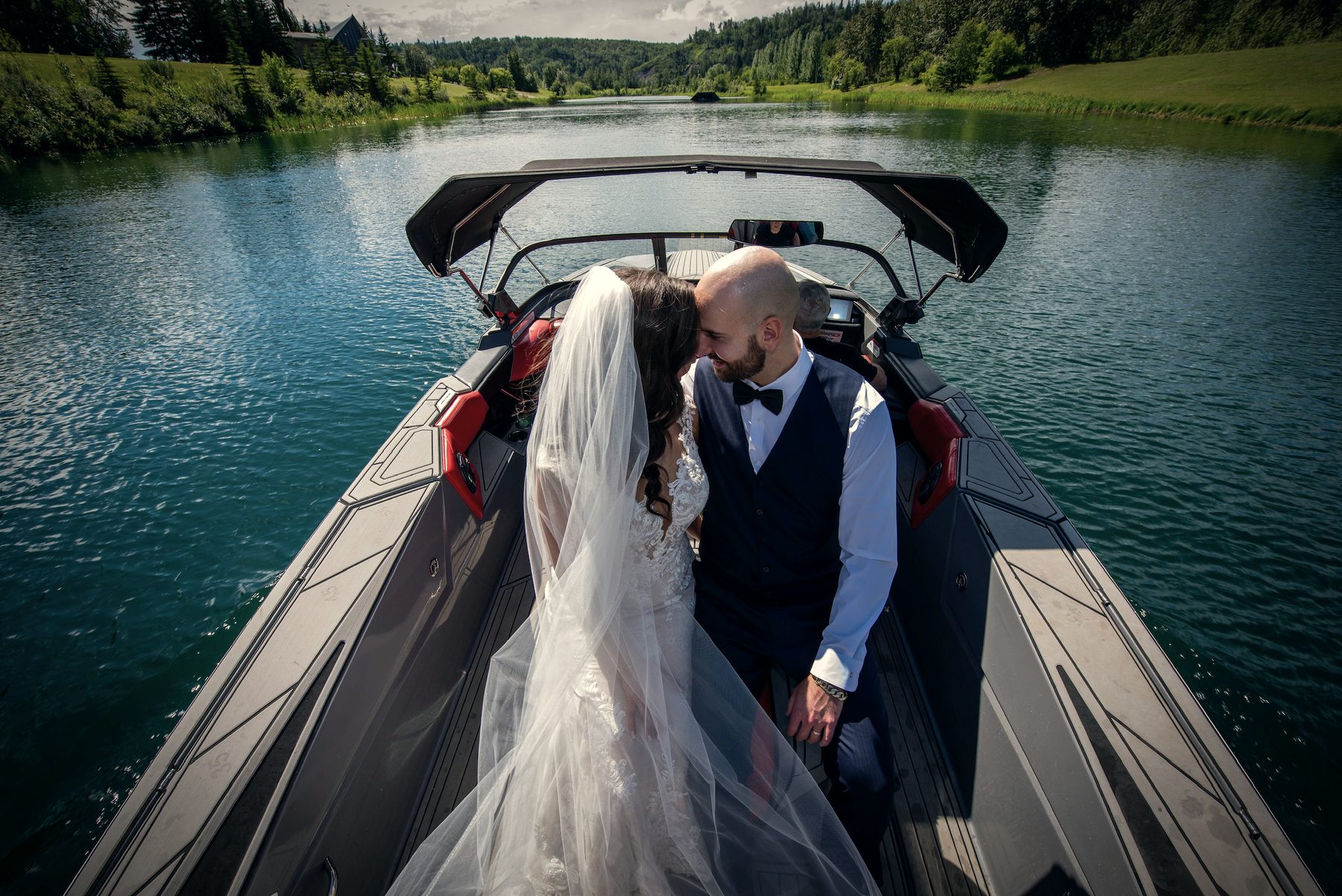 A kiss in the back of the boat, her veil fanned across his shoulder, blue water all around