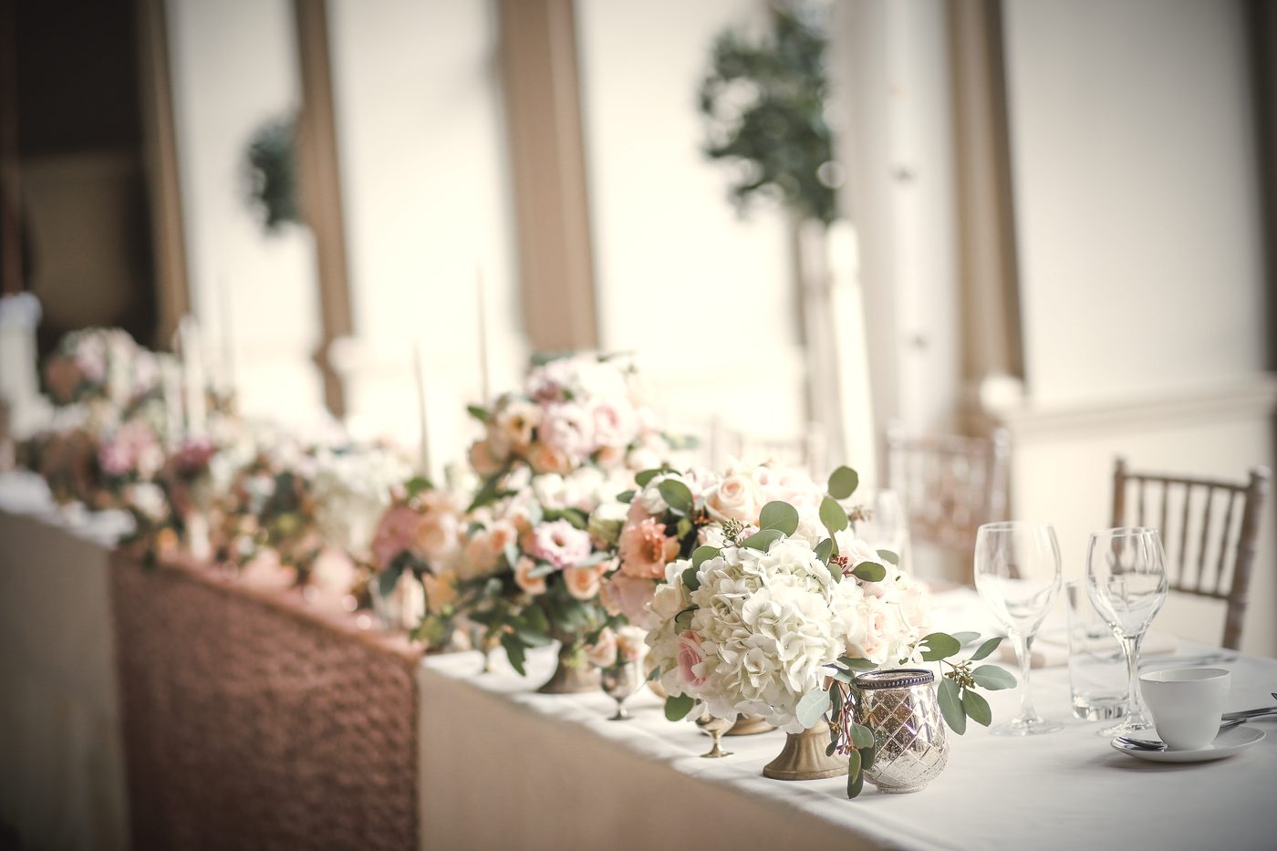 Blush and peach florals running the length of the head table