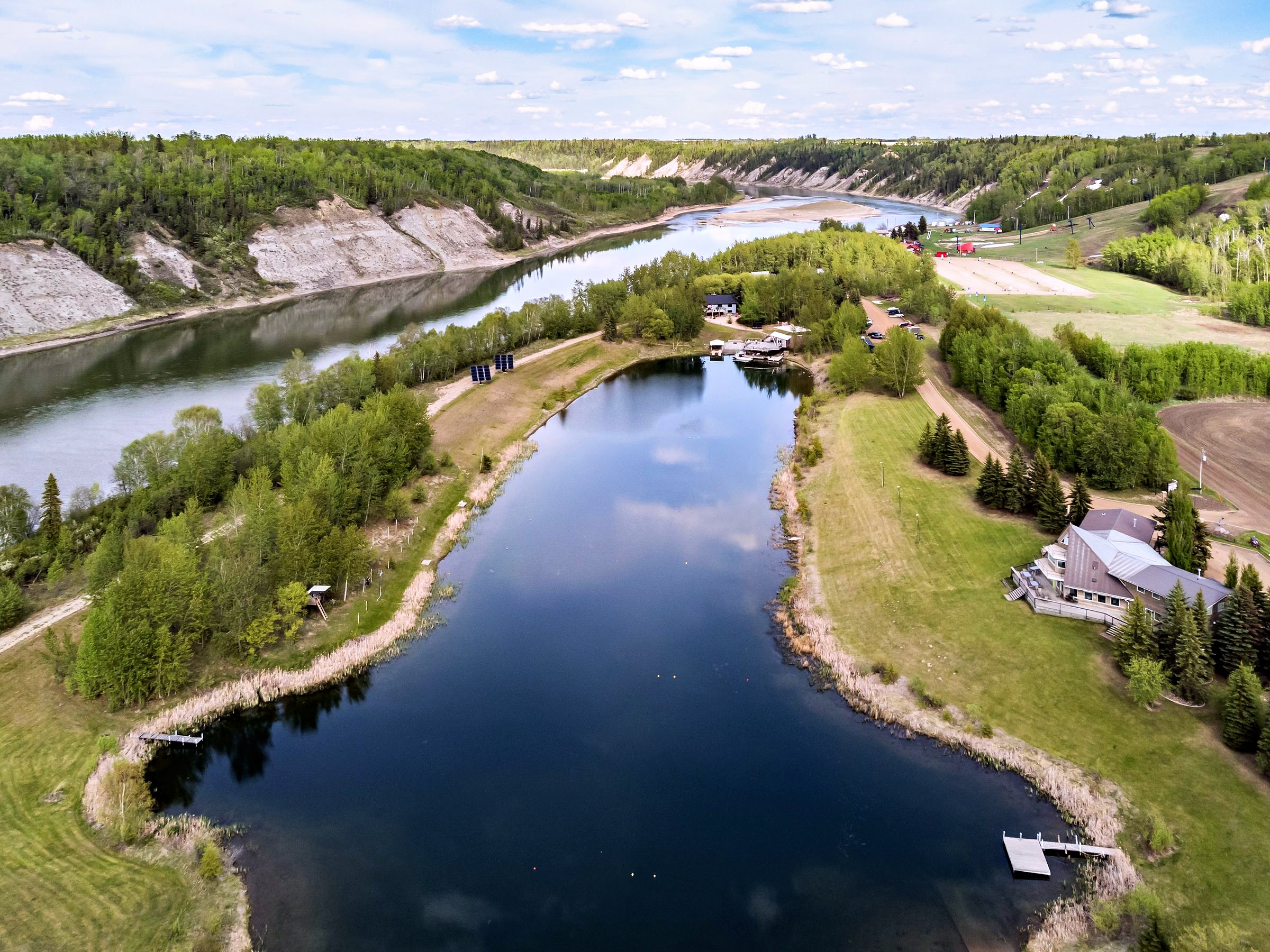 The property from the air, the lake along the valley floor, the river winding beyond it