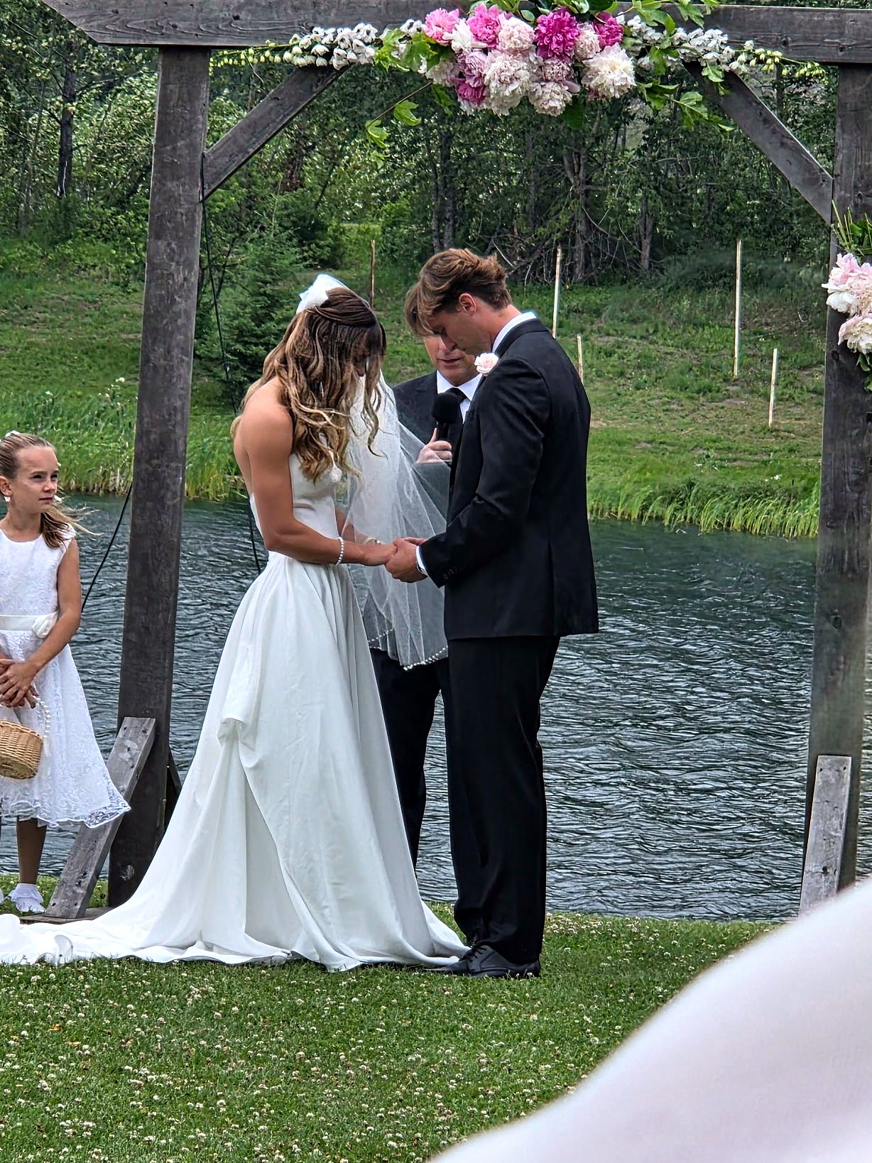 The vows at the arbour on the lawn, the lake directly behind